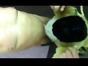 Gay man in fur coat suspended as a BDSM slave