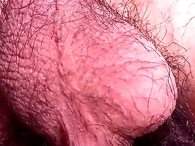 Close up of a hairy Asian boy’s balls swinging back and forth.