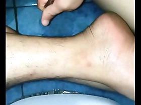 A solo boy gives a massage to himself at home.