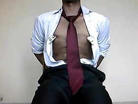Gay Asian man tied up in suit in solo BDSM scene