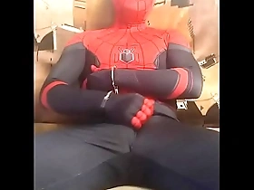 Gay Spidey in tight suit masturbates.