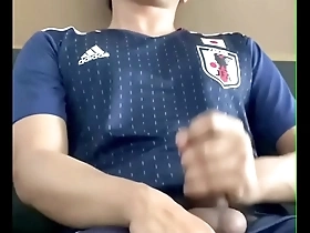 An uncut big cock in a Japanese football suit, an Asian man masturbates until he cums.