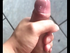 Asian man reaches climax while masturbating.